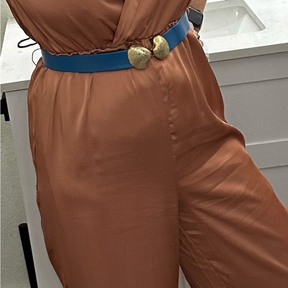 This silky romper is super cute. I am 5’5” & 135 lbs. it’s a salmon/ginger color - Picture 2 of 7